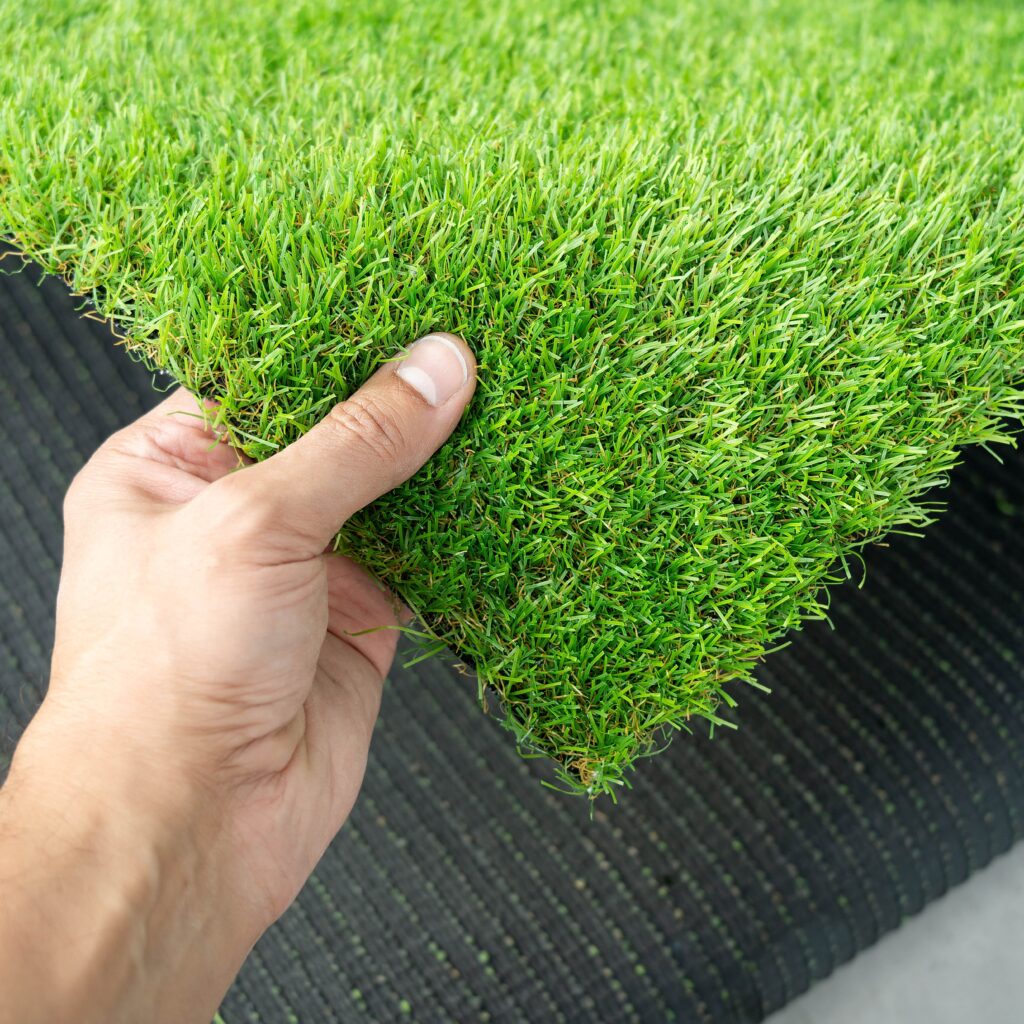 Square of turf being held